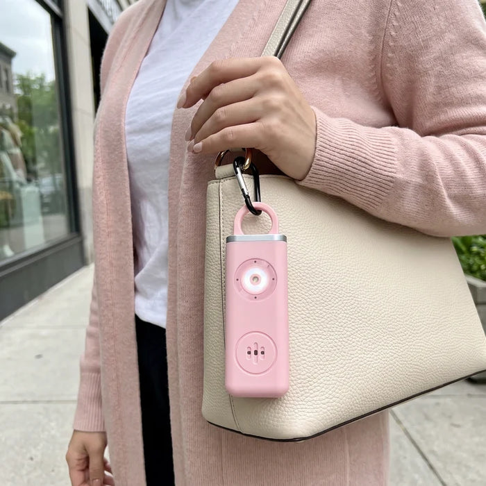 Pink ScreamKey clipped to a handbag